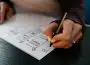person writing on white paper